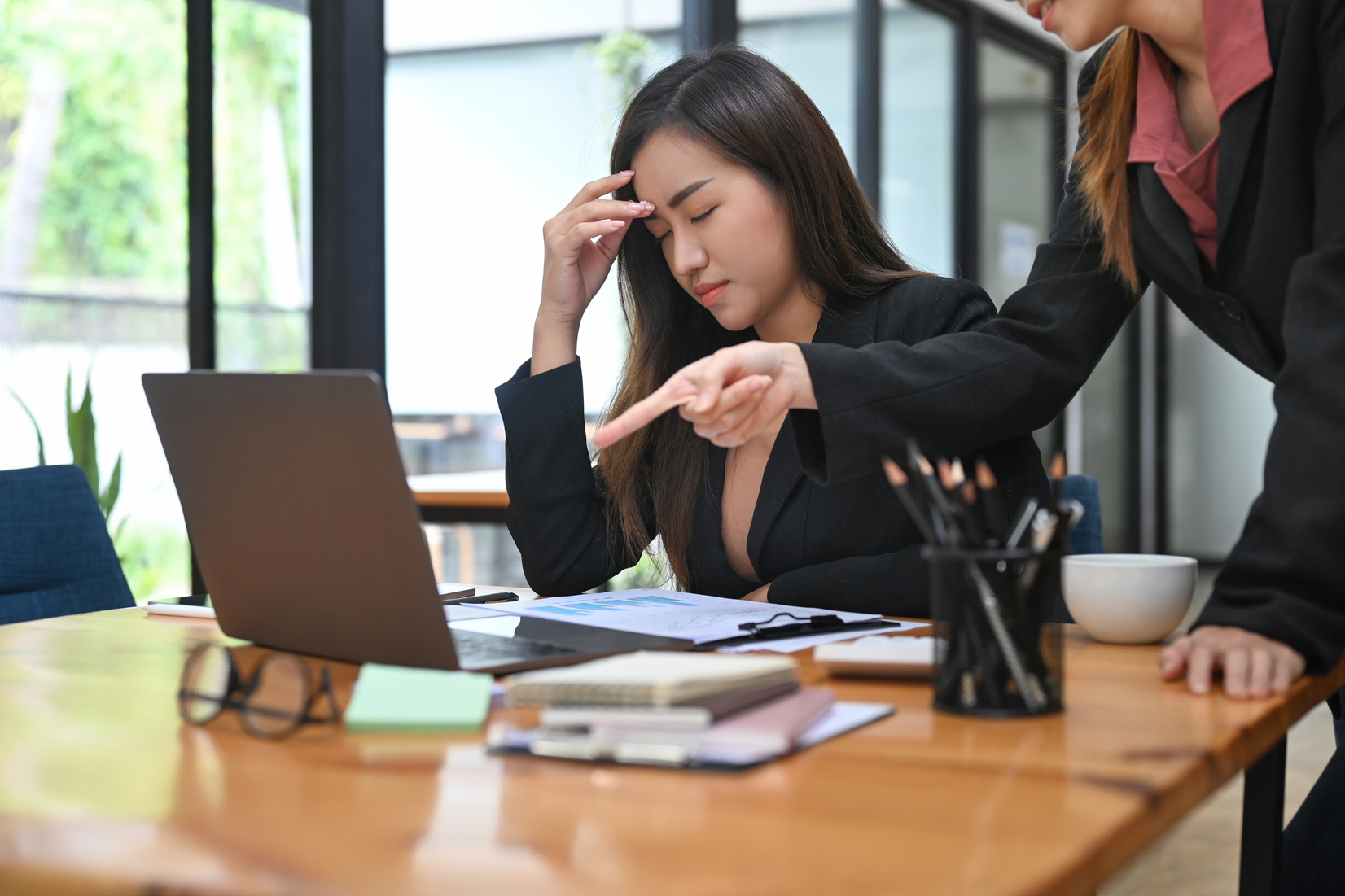 Dissatisfied boss scolding young employees, verbal warning about work failure.